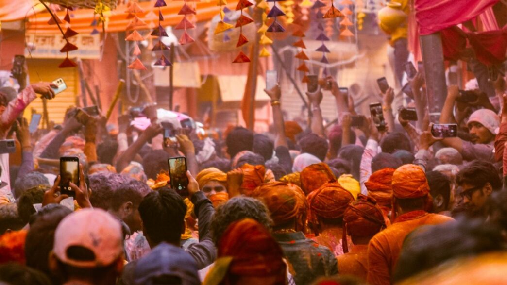 Crowd of people celebrating in a colorful street festival