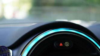a close up of a car dashboard with a blue light