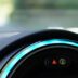 a close up of a car dashboard with a blue light