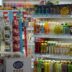 Shelves stocked with drinks and snacks in a store.