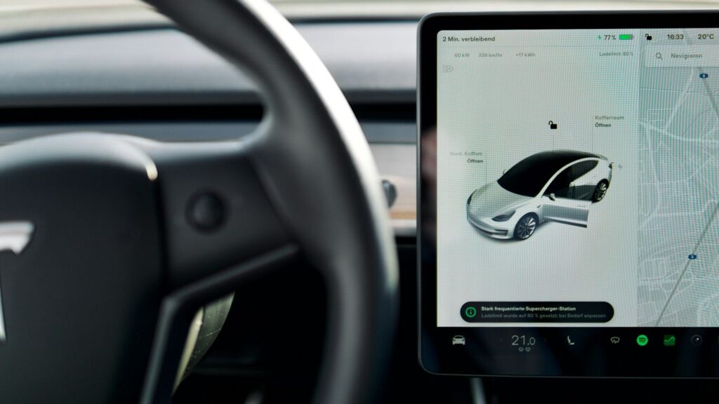 a car dashboard with a screen and a steering wheel