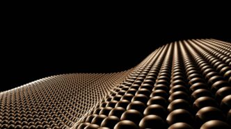 Bronze spheres forming a wavy surface against black