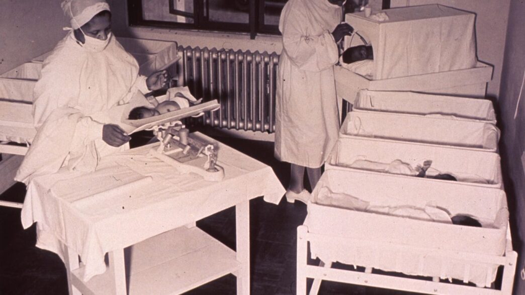 a black and white photo of nurses in a hospital
