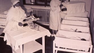 a black and white photo of nurses in a hospital