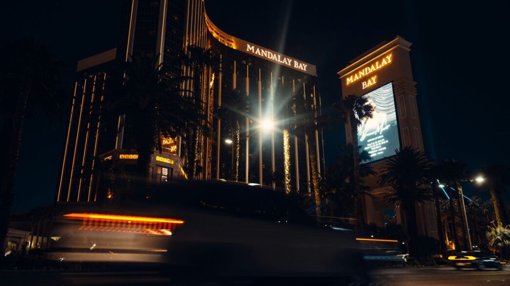 a bus driving down a street next to a tall building
