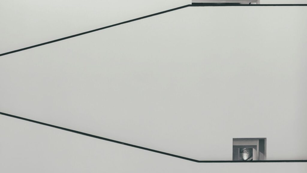 a black and white photo of a square object on a wire
