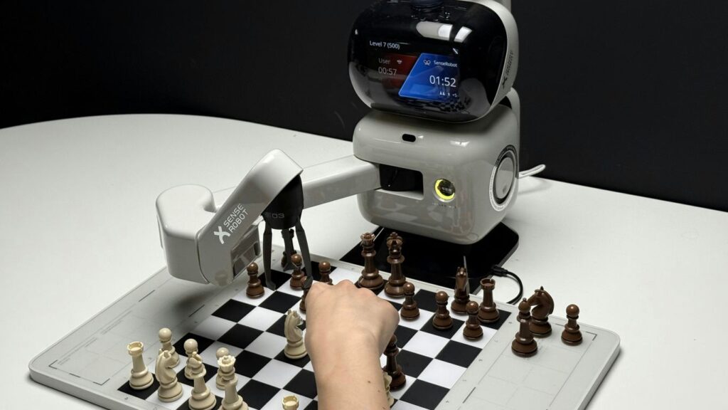 Robot arm playing chess with a human hand