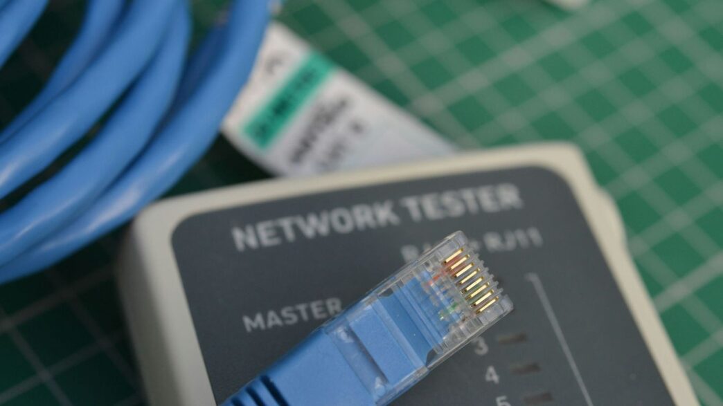 A close up of a network tester on a table