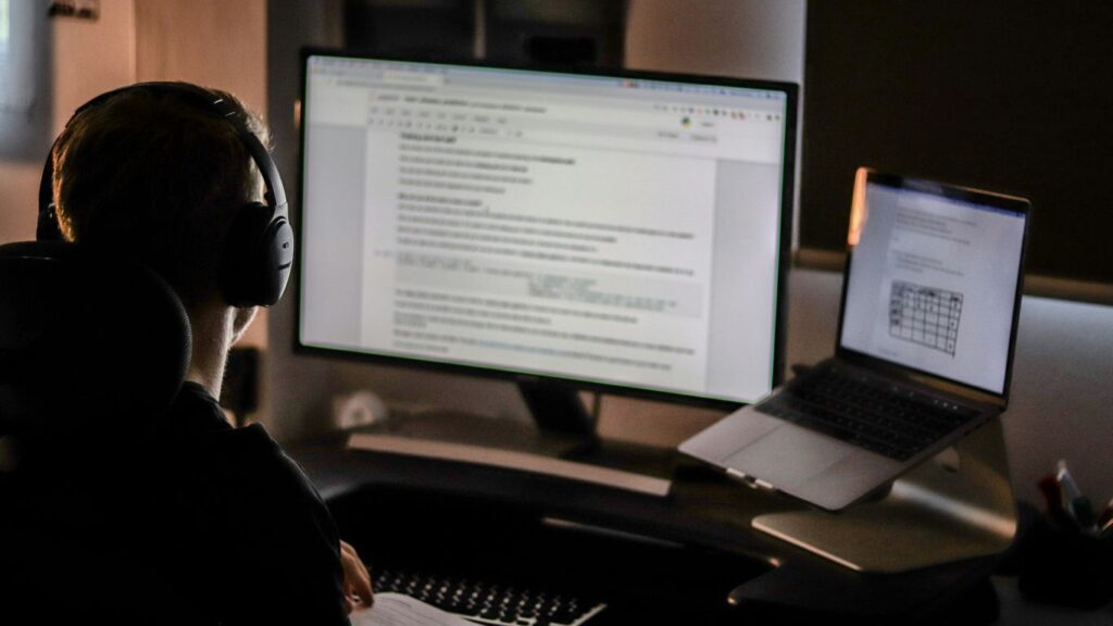 man using laptop computer and headphones