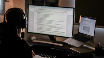 man using laptop computer and headphones
