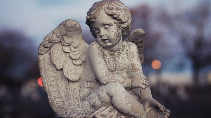 Stone angel statue in a cemetery at dusk