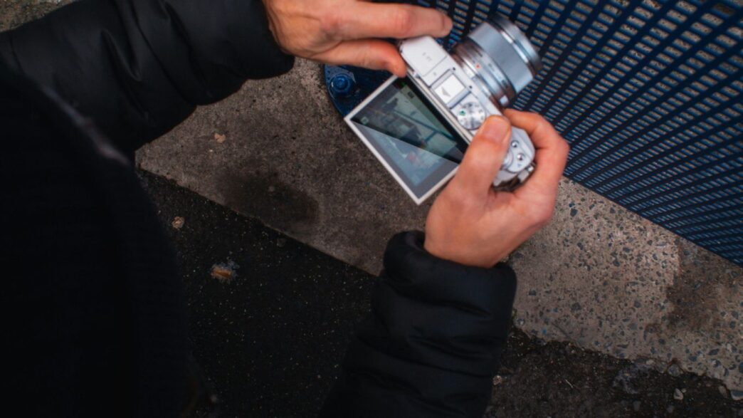a person holding a cell phone in their hand