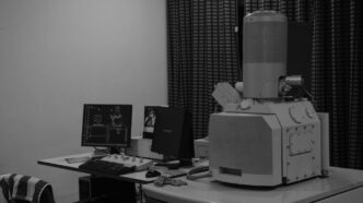 A black and white photo of a computer desk