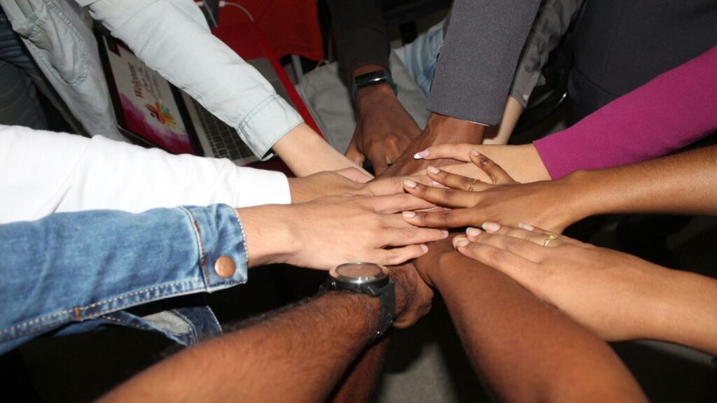 person wearing silver ring and white long sleeve shirt