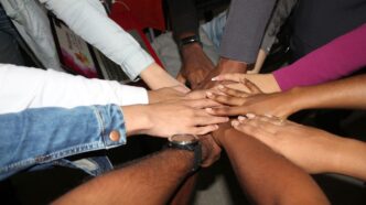 person wearing silver ring and white long sleeve shirt