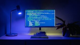 Code appears on a computer screen.