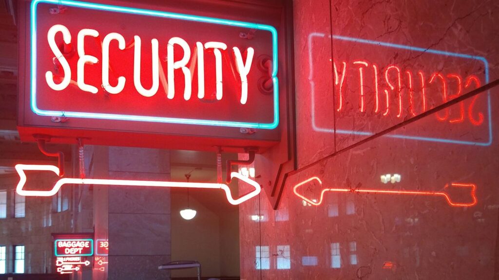 a red security sign and a blue security sign