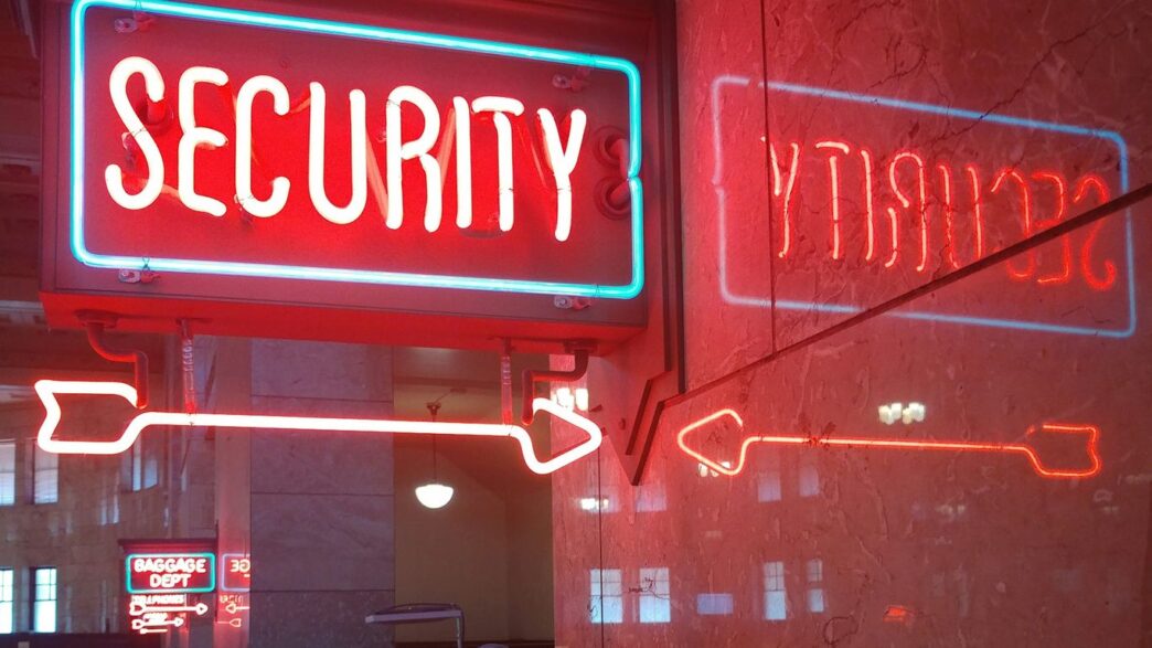 a red security sign and a blue security sign