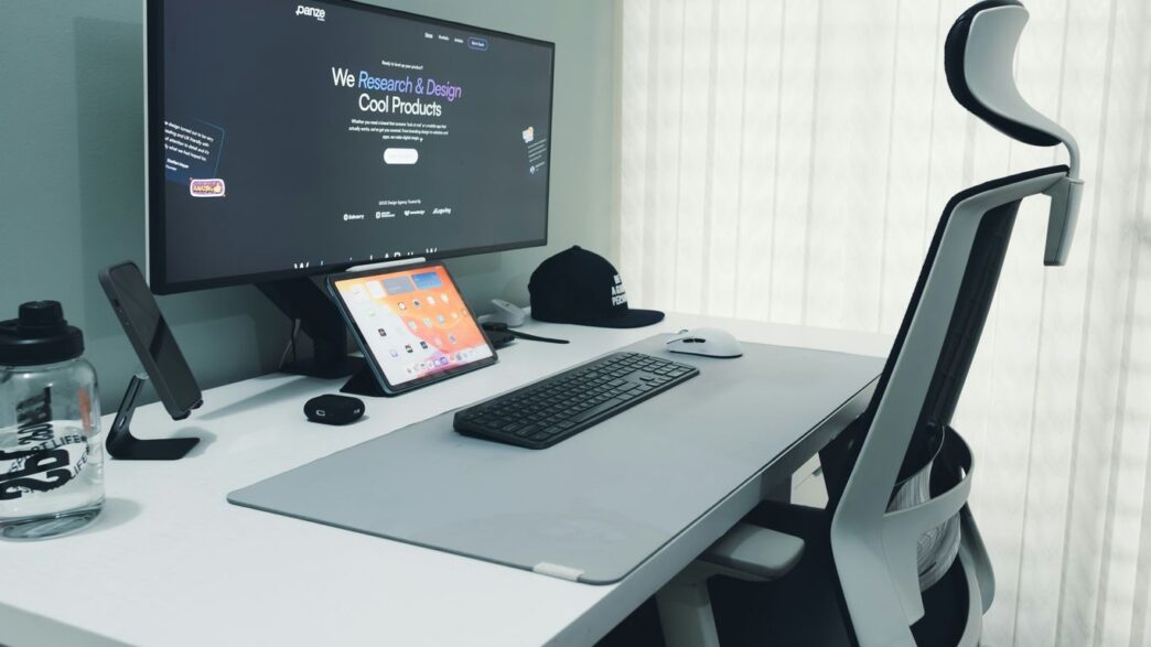Modern desk setup with computer and ergonomic chair