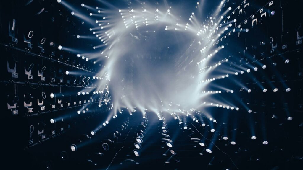 a dark room filled with lots of white lights