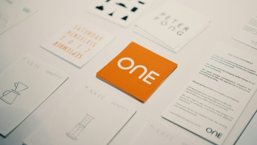 Orange card with "one" logo surrounded by other cards