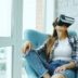 Woman wearing vr headset sitting in armchair
