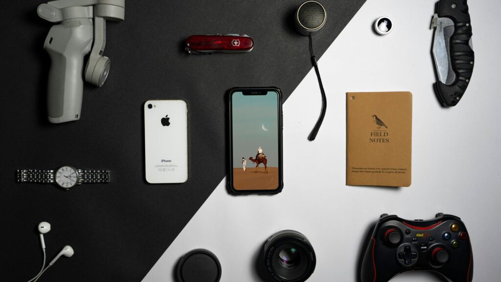 a collection of electronics and gadgets laid out on a table