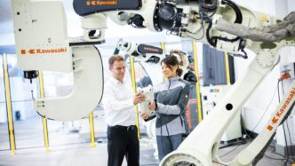 a man and a woman standing in front of a robot