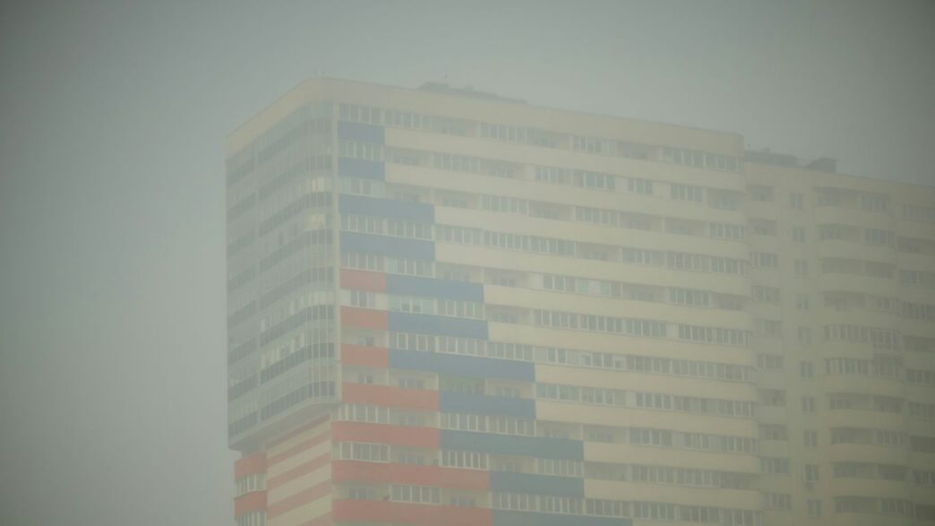 A tall building with a red white and blue flag on it