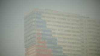 A tall building with a red white and blue flag on it