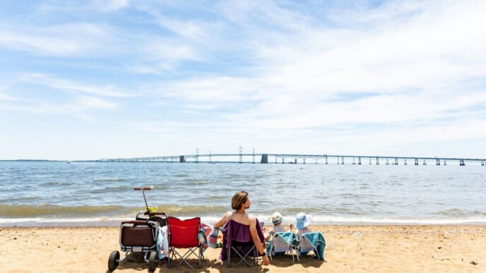 a woman sitting in a chair on the beach