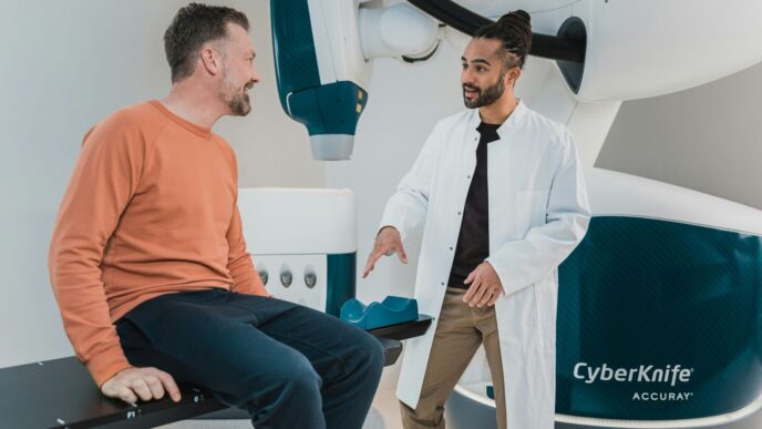 a person sitting on a chair next to a person in a suit