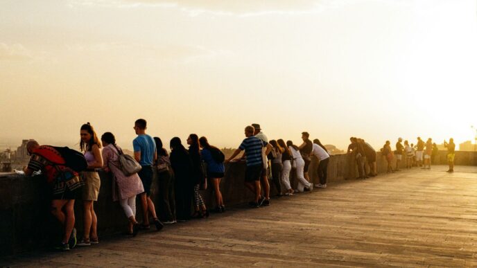 a group of people standing on top of a bridge