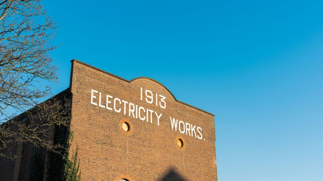 A brick building with a sign that says electricity works