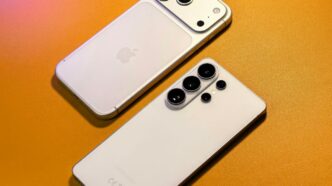 Two smartphones with multiple cameras arranged on orange surface