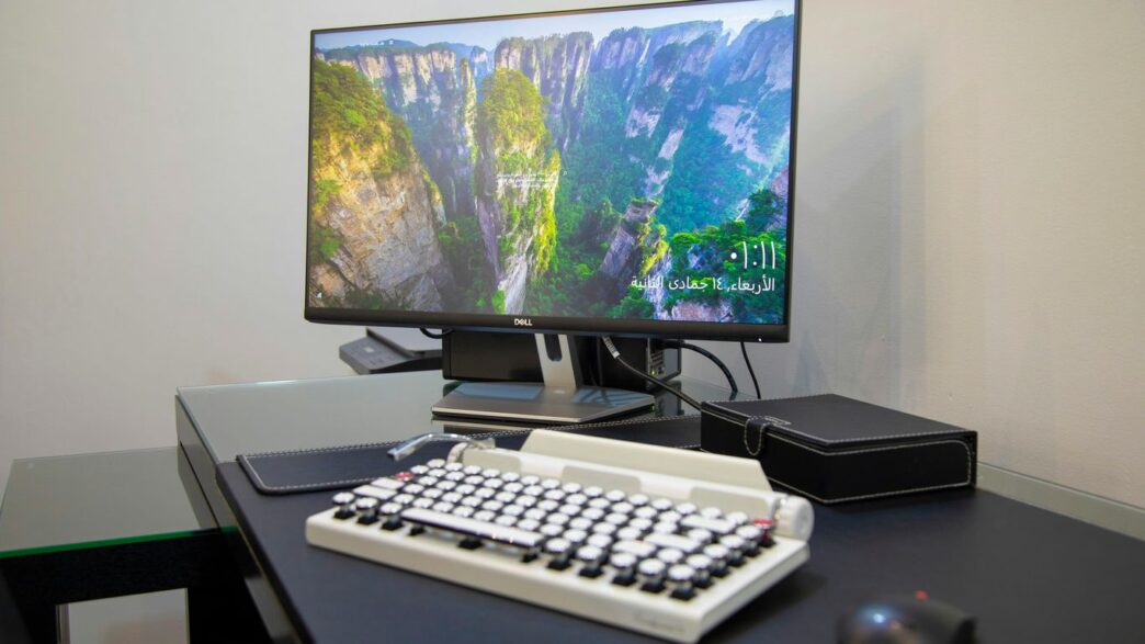 black flat screen computer monitor on white computer keyboard