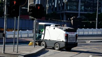 Street sweeper cleaning a city intersection