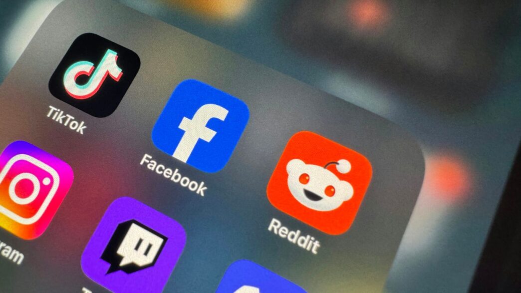 a close up of a cell phone with social icons on it