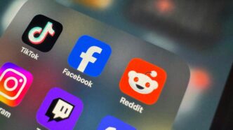 a close up of a cell phone with social icons on it