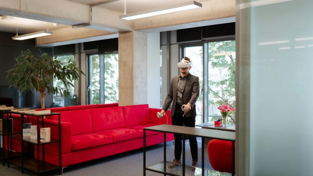 a man standing in a room with a red couch