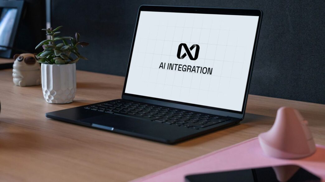 Laptop displaying ai integration logo on desk