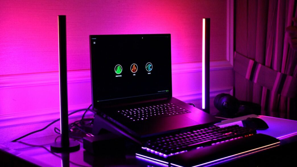 Gaming setup with laptop, keyboard, and rgb lighting.
