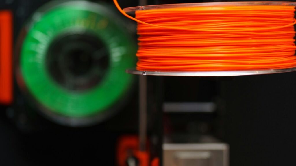 Orange and green filament spools.