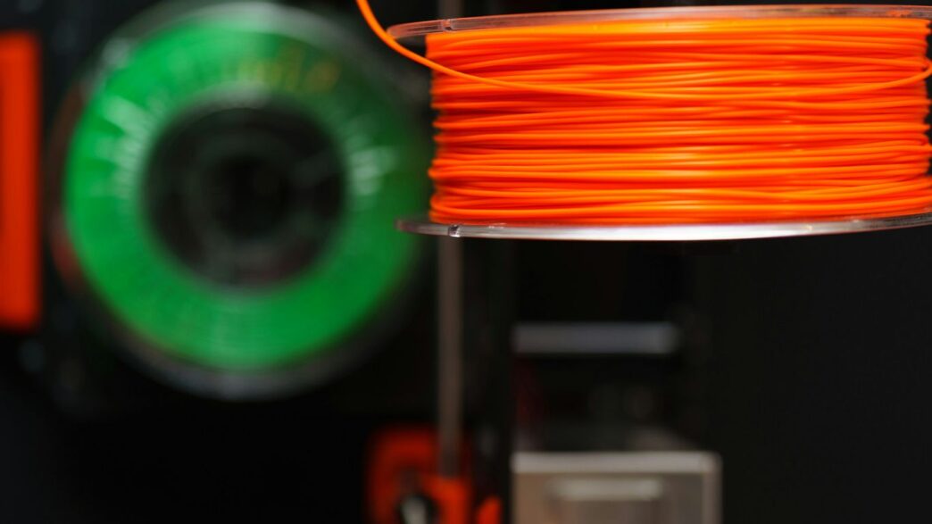 Orange and green filament spools.
