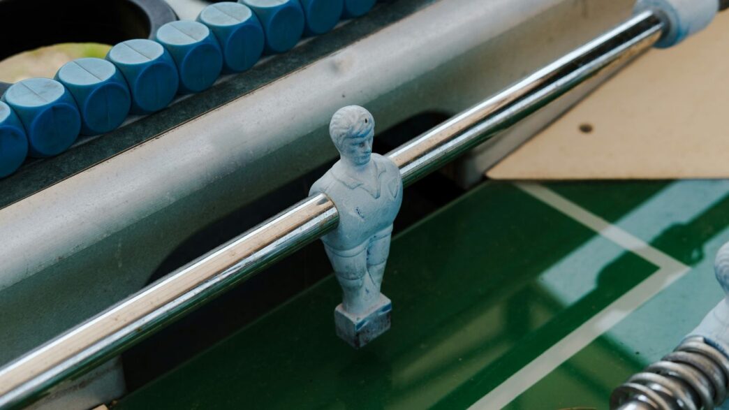 Foosball table: close up of a player rod.