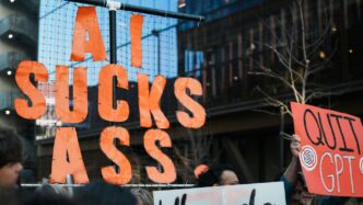 Protestors hold signs against ai and gpt.