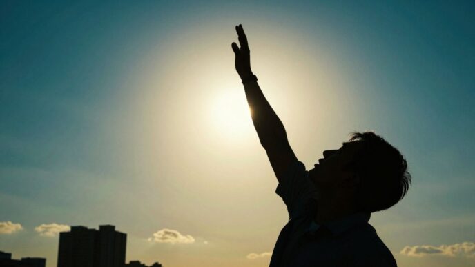 Person reaching upwards towards success and growth.