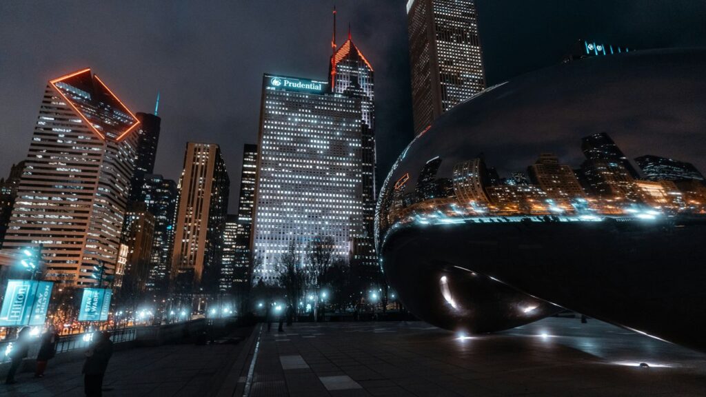 black car on road near high rise buildings during night time