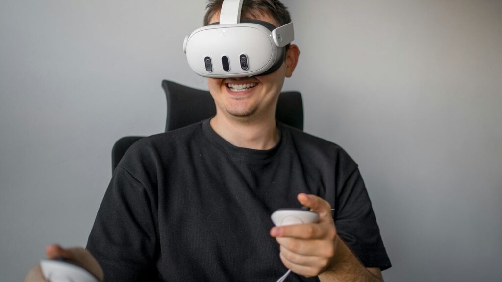 a man sitting in a chair holding a remote control