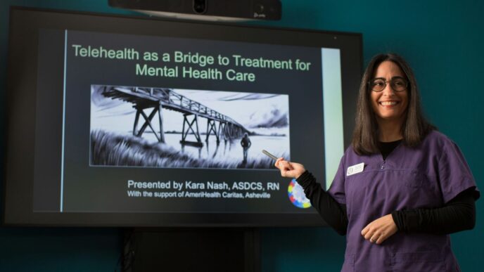 a woman standing in front of a projector screen